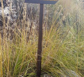 Rescue signs and the unpaved ascent route to the summit of Monte Monaco in Sicily