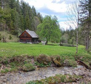 Hunting lodge with a small pond at the end of the trail