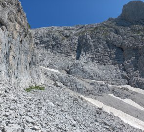 Wrinkled rocks and snow fields by the road