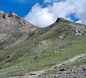 A small saddle where the path turns down to the river.