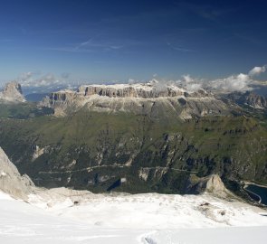 View from the summit ridge of Sassolungo, the Sella massif and Mount Piz Boe and Lago di Fedaia