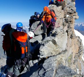 Top of Gran Paradiso - crowd for a photo with the Madonna of the Peak