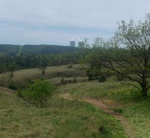 The view is dominated by the chimneys of the Dukovany power plant